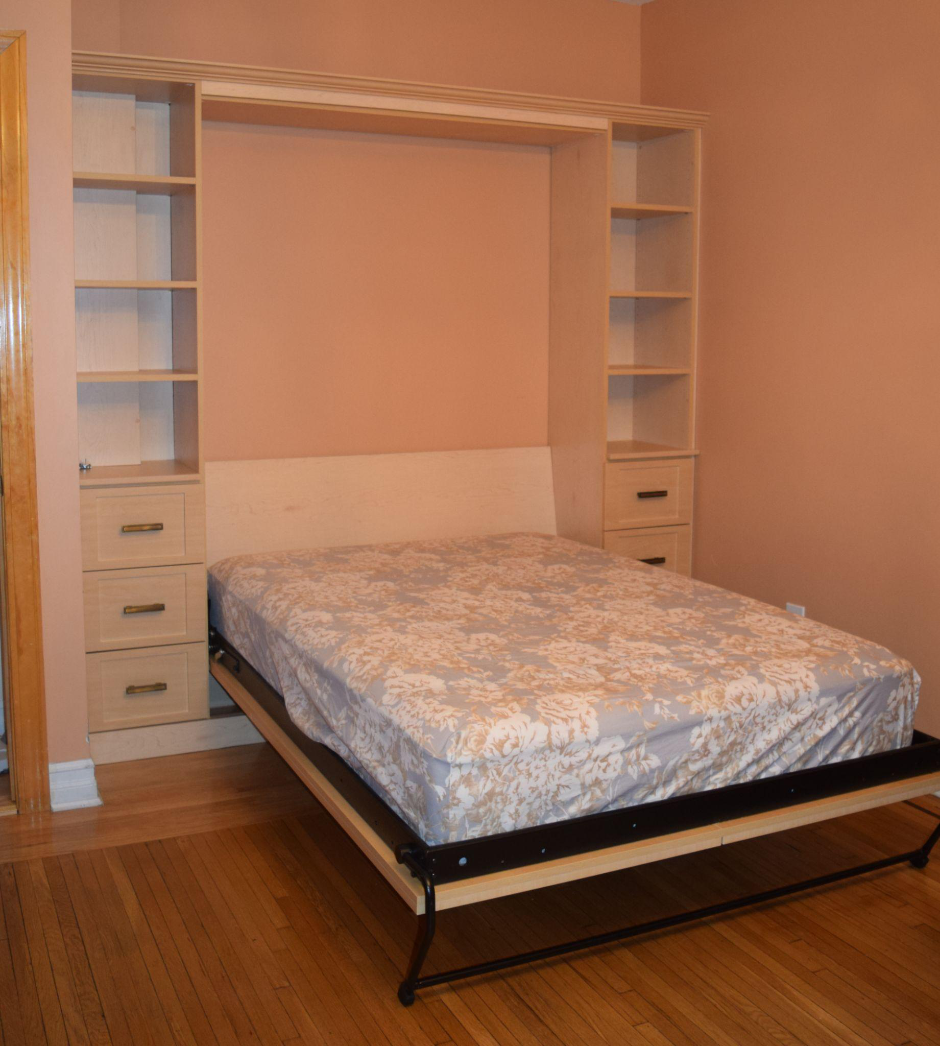 A wall bed with shelving 